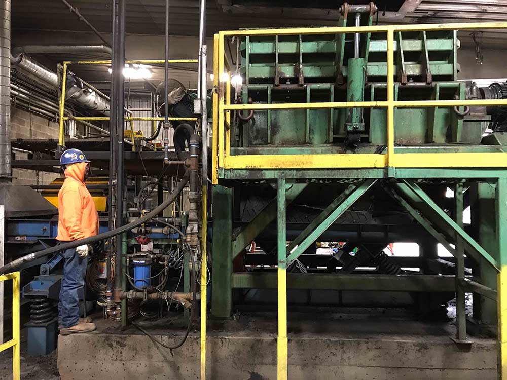 Tire recycling center with yellow and green railing/scaffolding